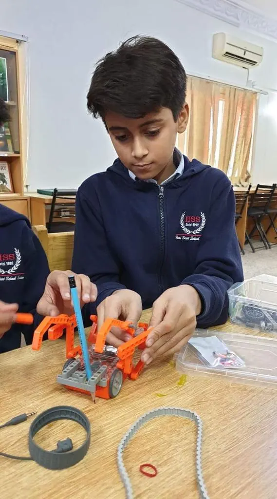 Student assembling automated lifting robot